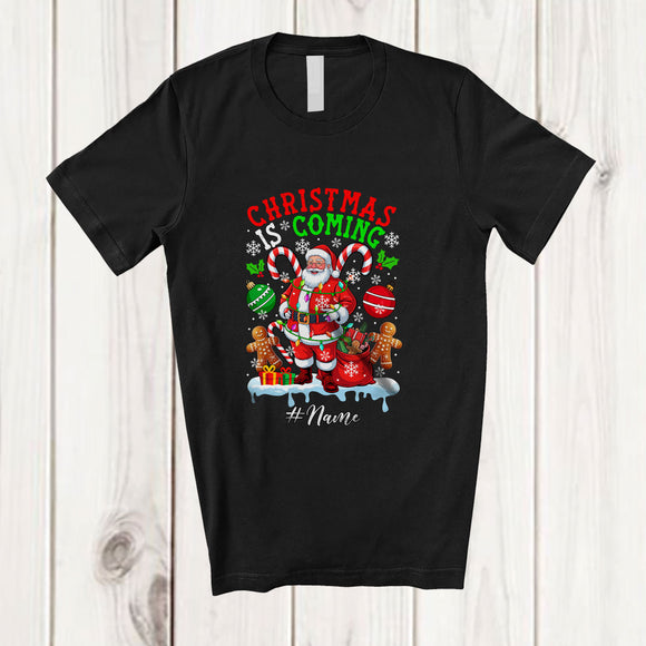 MacnyStore - Personalized Custom Name Christmas Is Coming; Amusing X-mas Santa Candy Cane; Family T-Shirt