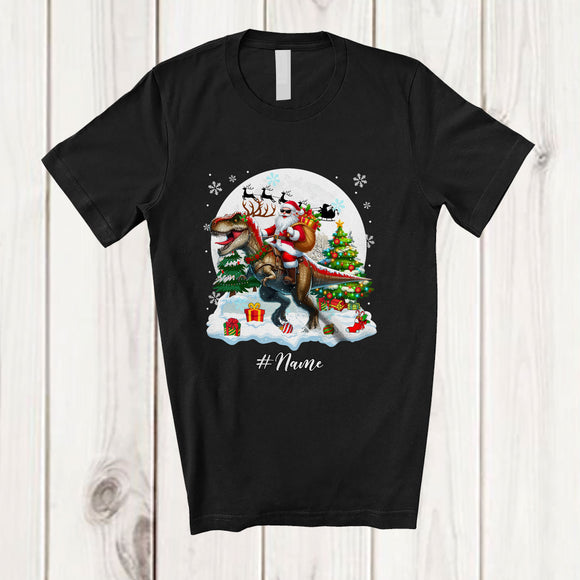 MacnyStore - Personalized Custom Name Santa Riding T-Rex Reindeer; Amusing Christmas Snow Dinosaur T-Shirt