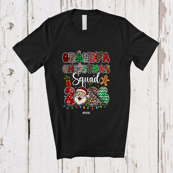 MacnyStore - Personalized Custom Name Grandpa Christmas Squad 2026; Joyful Leopard Plaid Santa Face Family T-Shirt