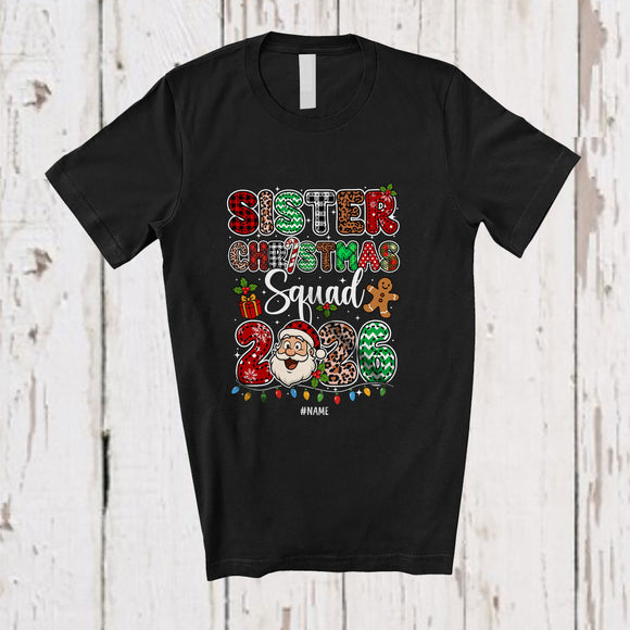 MacnyStore - Personalized Custom Name Sister Christmas Squad 2026; Joyful Leopard Plaid Santa Face Family T-Shirt