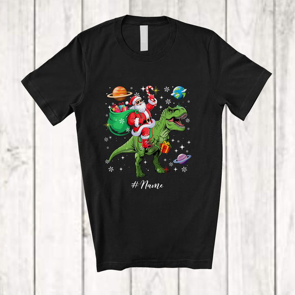 MacnyStore - Personalized Custom Name Santa Riding T-Rex; Awesome Christmas Santa In Space Galaxy T-Shirt