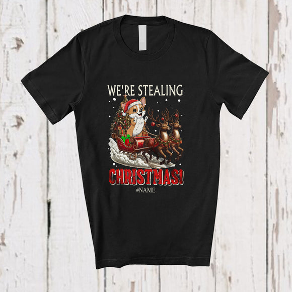 MacnyStore - Personalized Custom Name We're Stealing Christmas; Amusing Santa Corgi Sleigh Reindeer T-Shirt