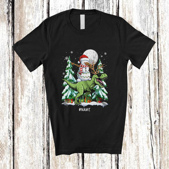 MacnyStore - Personalized Custom Name Dabbing Snowman Riding T-Rex Reindeer; Lovely Christmas Dinosaur T-Shirt