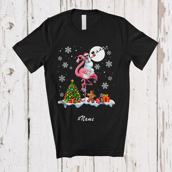 MacnyStore - Personalized Custom Name Dabbing Snowman Riding Flamingo; Cheerful Christmas Snow Animal T-Shirt