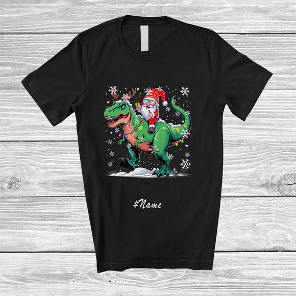 MacnyStore - Personalized Custom Name Gnome Riding T-Rex Reindeer; Lovely Christmas Light Dinosaur T-Shirt