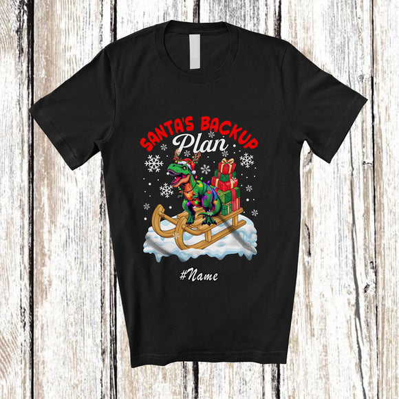 MacnyStore - Personalized Custom Name Santa's Backup Plan; Lovely Christmas Santa Sleigh Reindeer T-Rex T-Shirt