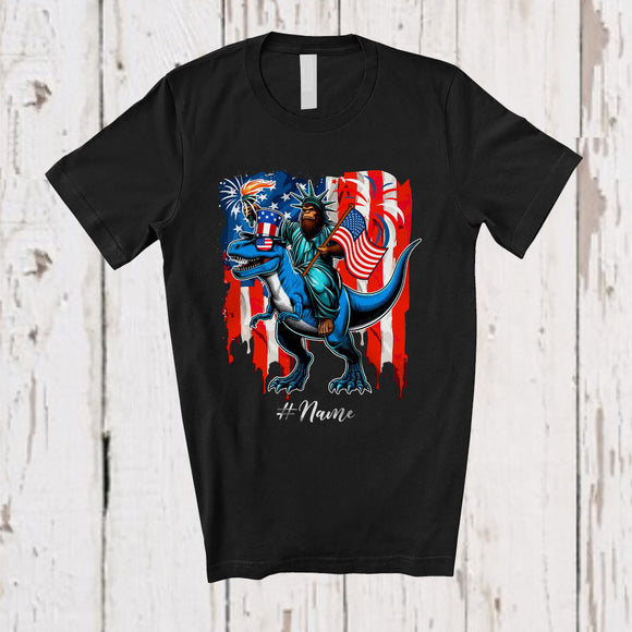 MacnyStore - Personalized Custom Name Bigfoot Liberty Riding T-Rex; Proud 4th Of July US Flag; Patriotic T-Shirt