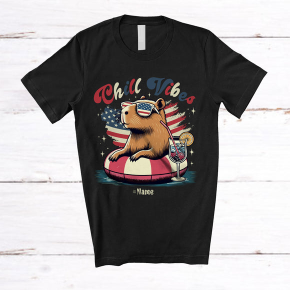 MacnyStore - Personalized Custom Name Chill Vibes; Lovely 4th Of July Capybara On Float US Flag; Patriotic T-Shirt