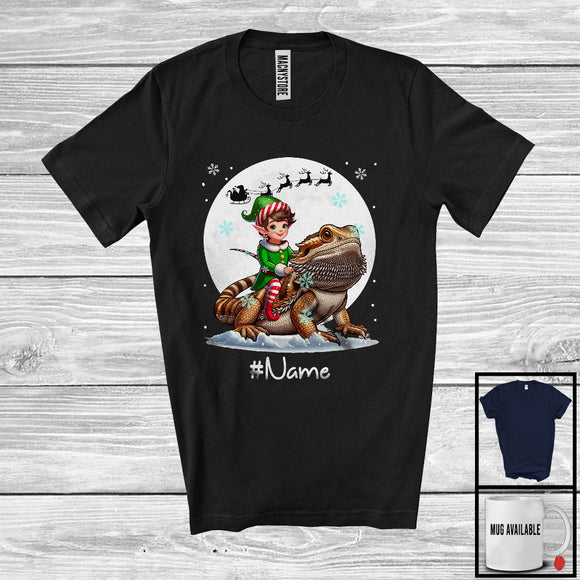 MacnyStore - Personalized Custom Name Elf Riding Bearded Dragon, Joyful Christmas Moon Snow, X-mas Team T-Shirt