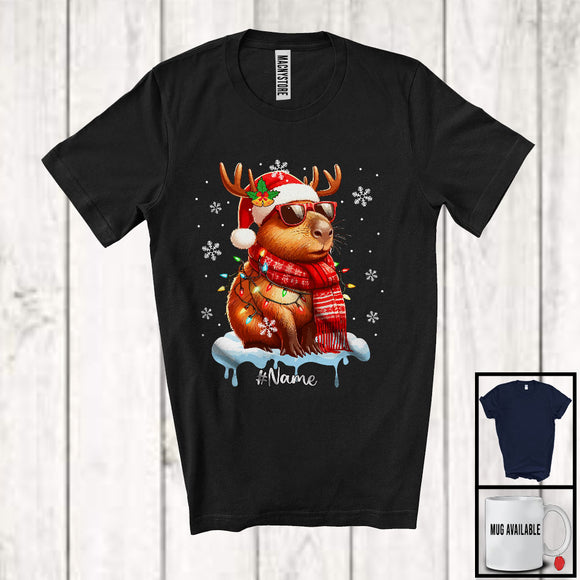 MacnyStore - Personalized Custom Name Reindeer Santa Capybara Sunglasses; Lovely Christmas Lights Snowing T-Shirt