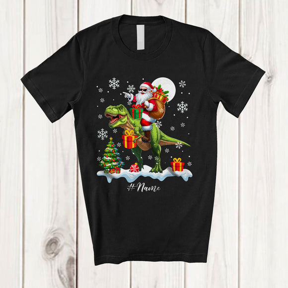 MacnyStore - Personalized Custom Name Santa Riding A T-Rex; Amazing Christmas Snowing T-Rex Wild Animal T-Shirt