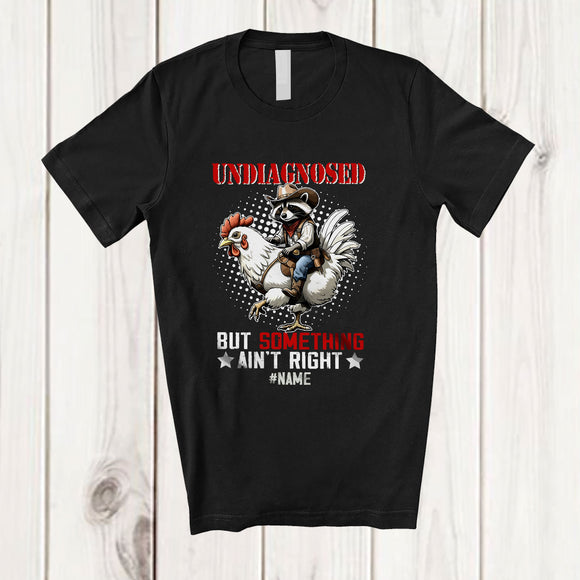 MacnyStore - Personalized Custom Name Undiagnosed Something Ain't Right; Joyful Raccoon Riding Chicken T-Shirt