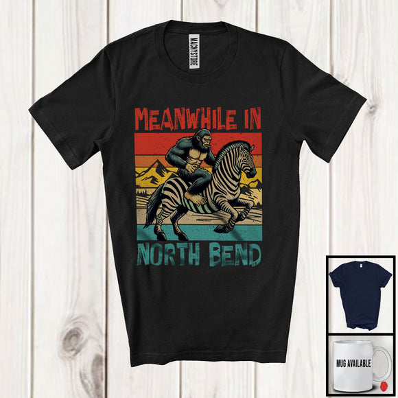 MacnyStore - Vintage Retro Meanwhile In North Bend, Humorous Bigfoot Riding Zebra, Animal Lover T-Shirt