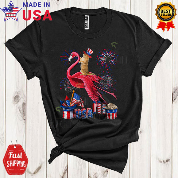 MacnyStore - Cat Riding Flamingo Funny Cool 4th Of July American Flag Fireworks Cat Wild Animal Lover T-Shirt