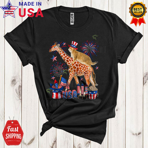 MacnyStore - Cat Riding Giraffe Funny Cool 4th Of July American Flag Fireworks Cat Wild Animal Lover T-Shirt
