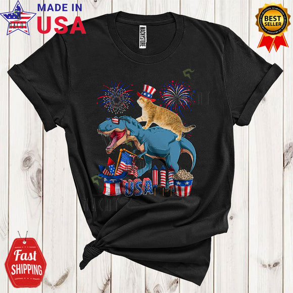 MacnyStore - Cat Riding T-Rex Funny Cool 4th Of July American Flag Fireworks Cat T-Rex Animal Lover T-Shirt