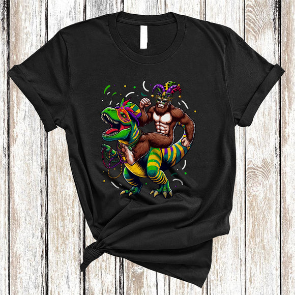 MacnyStore - Funny Bigfoot Riding Dinosaur, Cheerful Mardi Gras Mask Beads T-Rex, Mardi Gras Parade Squad T-Shirt
