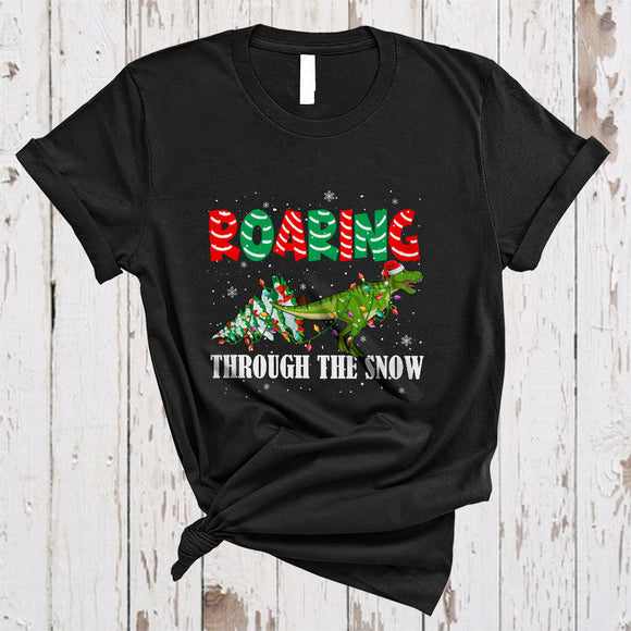 MacnyStore - Roaring Through Snow, Adorable Christmas Santa T-Rex X-mas Tree, Snow Around Dinosaur T-Shirt