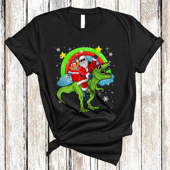 MacnyStore - Santa Riding Cute T-Rex, Funny Christmas Santa Package Rainbow, X-mas Dinosaur Lover T-Shirt